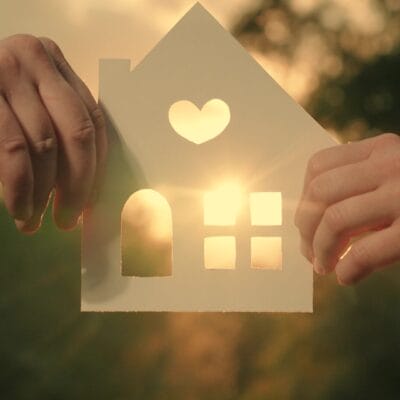 Hands holding a house